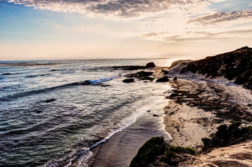 Rugged Beach Along Ocean at Sunset