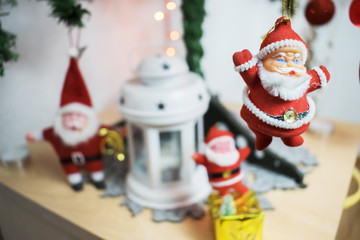 three Santa Claus on Christmas tree with a candle lantern