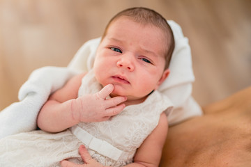 Portrait of newborn baby girl feels safe and awake to a new life.