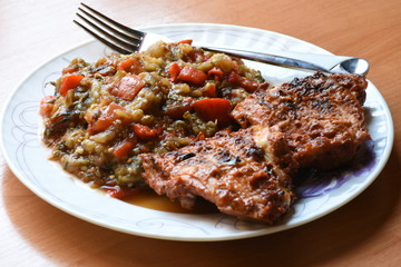 grilled beef steak with vegetables on white plate