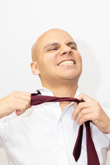 Bald man freeing himself from his tie