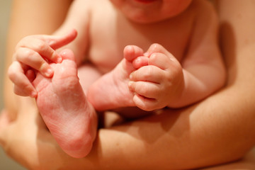 Very flexible baby biting and sucking his feet and hands.
