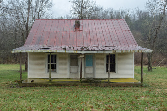 Old duplex farmhouse in grass field