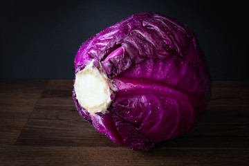 low key image of a head of raw purple cabbage