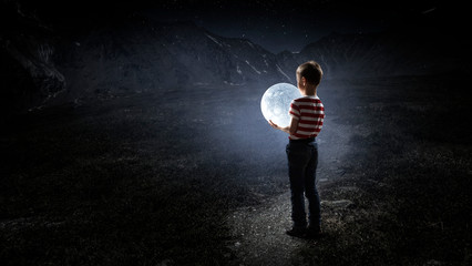Obraz premium Boy holds the moon . Mixed media