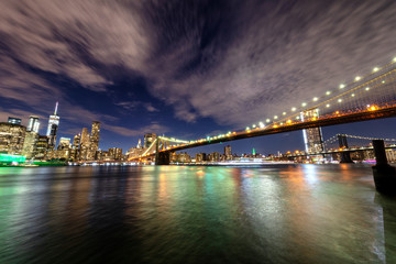 Manhattan skyline and Brooklyn Bridge by night