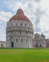 Fototapeta premium Pisa Bapistry and Cathedral over the lawn of Cathedral Square in Pisa, Italy