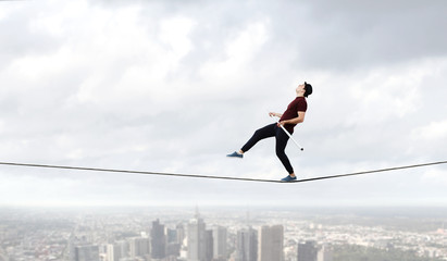 Brave ropewalker on cable. Mixed media