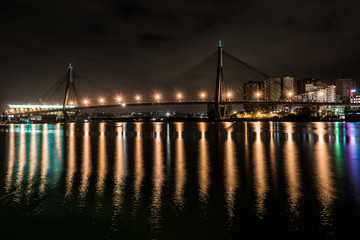 Fototapeta na wymiar bridge at night wit reflections and apartments