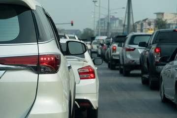 White car on the road in traffic junction there are many cars on the road.