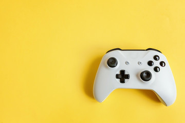 White joystick gamepad, game console on yellow colourful trendy modern fashion pin-up background....