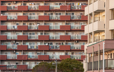 Glass and brick balconies with laundry outside in Japanese apartment block