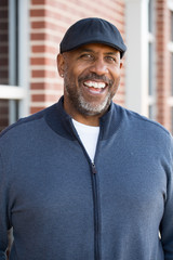 Portrait of an African American ssmiling outside.
