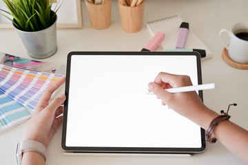 Graphic designer hand using digital tablet pen in studio