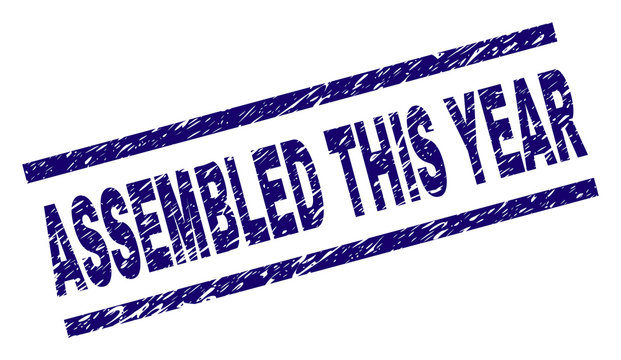 ASSEMBLED THIS YEAR seal print with grunge style. Blue vector rubber print of ASSEMBLED THIS YEAR text with unclean texture. Text caption is placed between parallel lines.