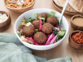 Mediterranean falafel balls. Vegan fried falafel bowl with salad. A staple in Egypt and Israel cuisine. 
