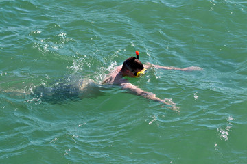man snorkeling in the sea