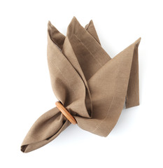Fabric napkin with decorative ring for table setting on white background