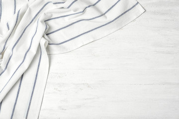 Fabric napkin and space for text on wooden background, top view