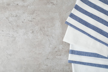 Fabric napkins and space for text on gray background, top view