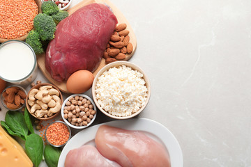 Set of natural food high in protein and space for text on light background, top view