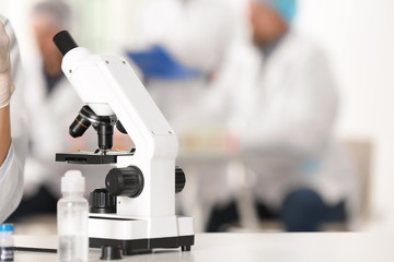 Modern microscope on table in laboratory, space for text. Research and analysis