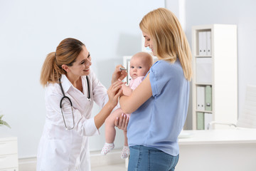 Woman with her baby visiting children's doctor in hospital