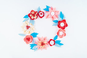 Flower made of coral color paper. The pink color of the curl and leaf.