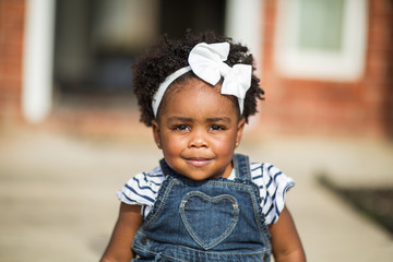 Happy little girl laughing and smiling outside.