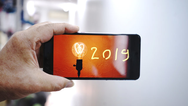  Smart phone screen showing  number 2019 .happy new year concept idea   