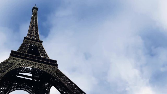Eiffel Tower Upshot with Time Lapse Clouds Background Loop – This video features a view of looking up at the Eiffel Tower with time lapse clouds in the background in a loop and ready for your custom t