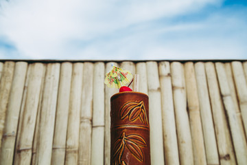 cocktail against the bamboo wall and sky