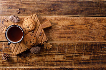 Cup of tea with oatmeal cookies on a wooden background. Flat lay. Space bar under your text.