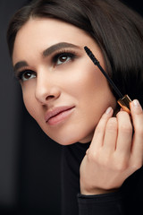 Mascara Makeup. Beauty Model Putting Black Mascara On Eyelashes