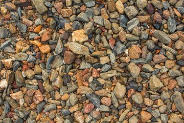 blue gray yellow red stones of different sizes. natural surface texture
