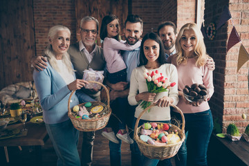 Close up photo of people gathered family cuddle each other stand