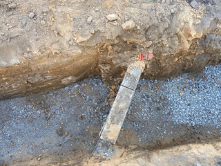 Underground crossing of town and houses utilities under pavement