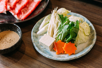 Sukiyaki vegetables set including cabbage, false pak choi, carrot, shiitake, enokitake and tofu.