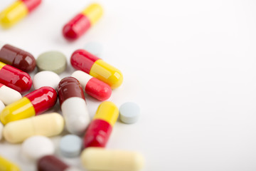 Medicine pills, tablets and capsules over white background