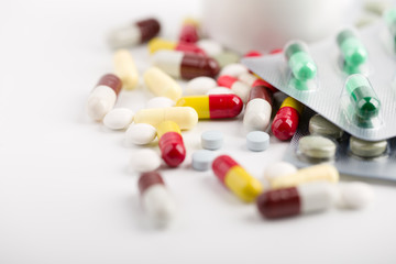 Medicine pills, tablets and capsules over white background