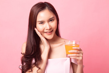 Young Asian woman happy smile with orange juice