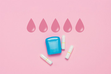 Feminine hygiene tampons and box for shipping and storage on a pink background. Concept of feminine hygiene during menstruation. Added drop mark, absorption level. Five drops. Flat lay, top view