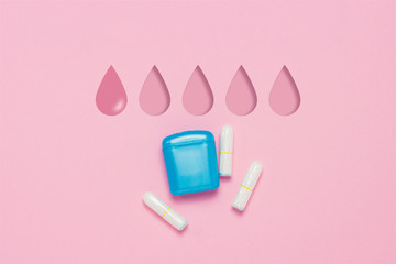 Feminine hygiene tampons and box for shipping and storage on a pink background. Concept of feminine hygiene during menstruation. Added drop mark, absorption level. One drop. Flat lay, top view