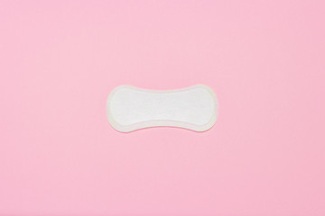 Feminine hygiene pad on a pink background. Concept of feminine hygiene during menstruation. Flat lay, top view © Alex