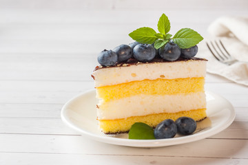 Cake of a souffle with glaze and fresh blueberries. copy space