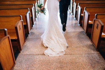 bride and groom walking down church aisle after ceremony