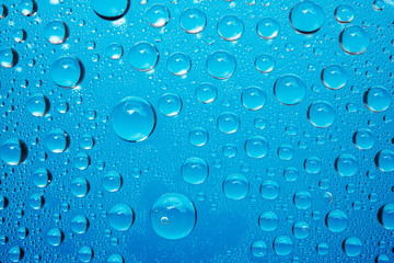 Water Droplets On Blue Background.