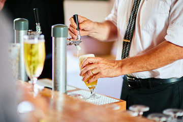 Fototapeta na wymiar man preparing alcoholic drinks at bar