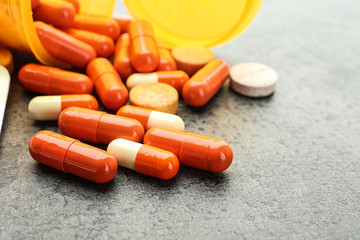 Orange pills on grey background