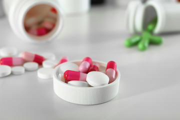 Plastic cap with pills on table